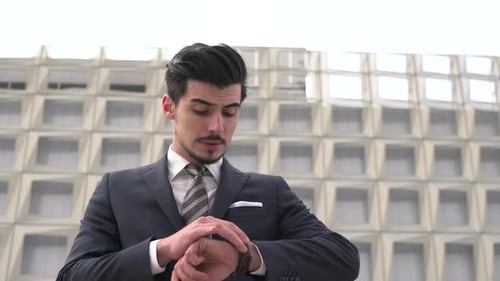 Young Adult Man in Suit Looks to Camera