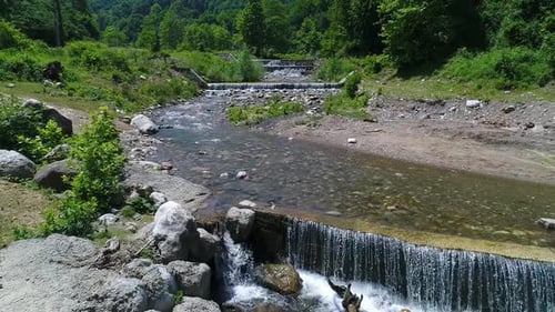 Weirs on the stream. Artificial waterfall flow of water.