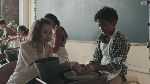 Children Learning Pottery in a Bright Classroom