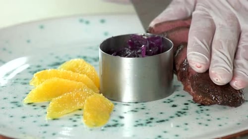 Gourmet Meal Plating Meat, Orange, and Red Cabbage