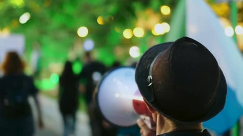 Man Speaks into Megaphone at Outdoor Event