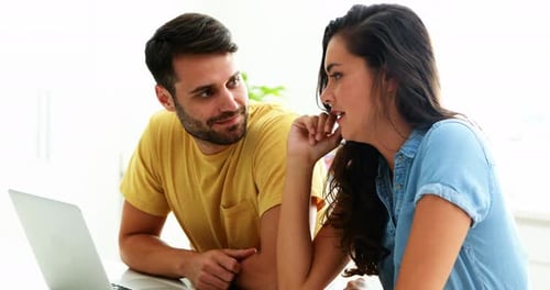 Young Adults Laughing Looking at a Laptop