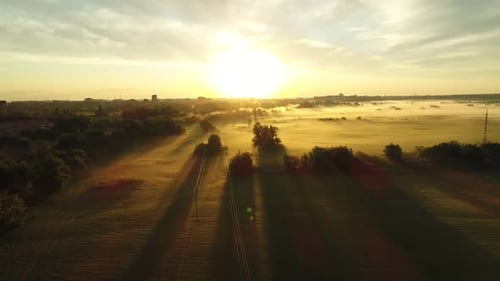 Sunrise Over Foggy Rural Landscape