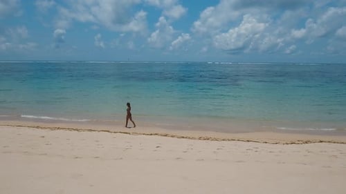 Girl Walking on the Beach