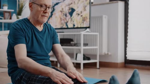 Close Up of Aged Man Doing Stretch Exercise on Yoga Mat