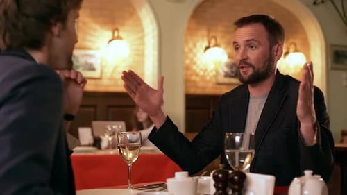 Two Men Talking in Restaurant Setting