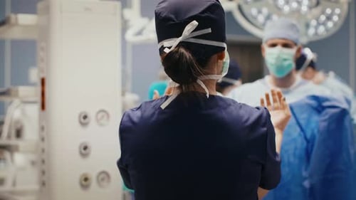 Rear view of doctors before hard operation