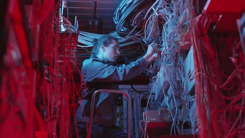 Maintenance Worker Repairing in Server Room