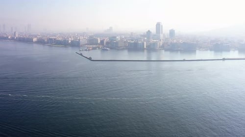 Beautiful Scenery of Metropolis with Highrise Buildings at Sea with Morning Sky in the Background