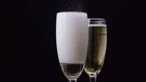 Champagne Poured Into Glass. Black Background. Close Up