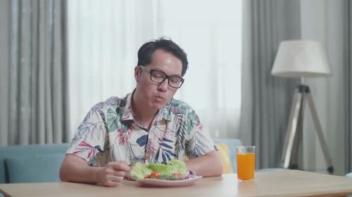 Man Eating a Healthy Salad Indoors