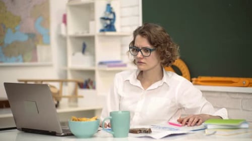 Woman Teaching Online at School Desk