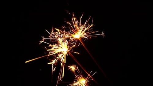 Golden Sparklers Bursting with Festive Light on Black