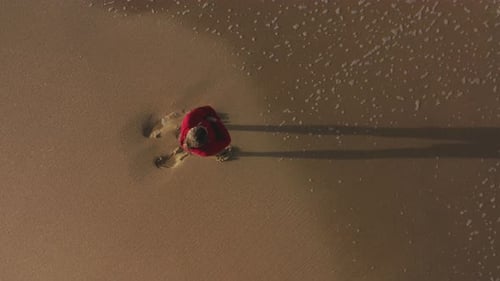 Aerial View of Handsome Man Observing Huge Open Ocean Waters Along a Beach