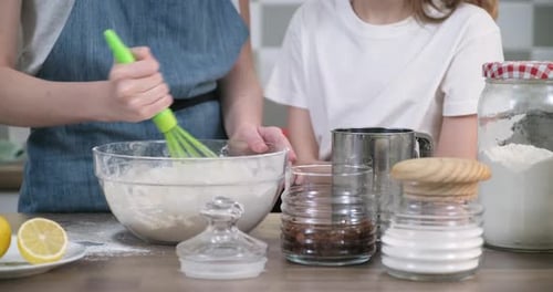 Close-up of Bowl with Dough, Childrens Hands Interfering with Spoon of Flour