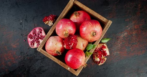 Fresh Pomegranates in Wooden Box Slowly Rotate