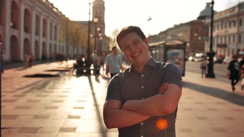 Portrait of Attractive Smiling Male Outdoors in Urban Environment. Street Sunrise
