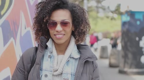 Beautiful Mixed Race Girl with Curly Hair Posing in Urban City Scenery
