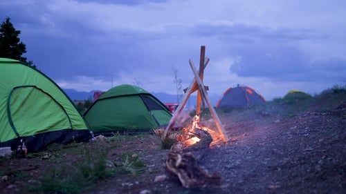 Campsite with Tents and Campfire at Night