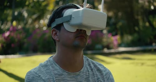 A Man in a Virtual Reality Helmet is Studying a Virtual Game