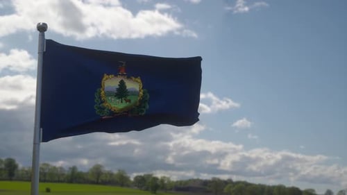 Realistic Waving Vermont State Flag in Blue Sky