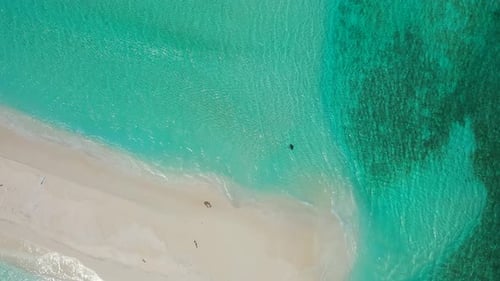 Daytime flying abstract view of a white paradise beach and turquoise sea background