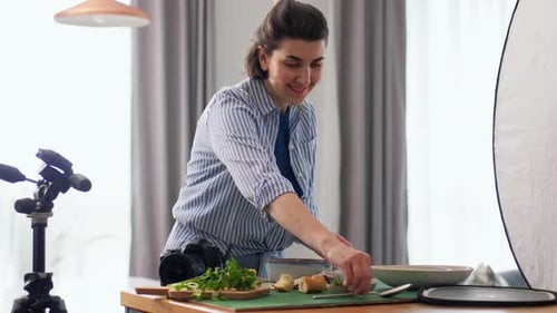 Woman Photographing Food with Digital Camera Indoors