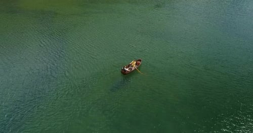 Young Couple In A Boat On The Background Of A Lake