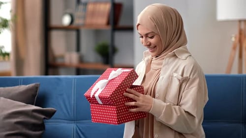 Smiling Young Muslim Female Opening Gift Box Looking Inside Happy Get Wished Birthday Present