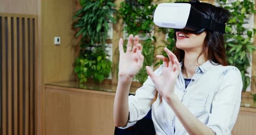 Woman Using Virtual Reality Headset in Modern Office