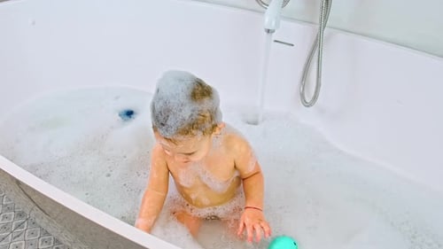 Cute Baby Playing in a Bubble Bath