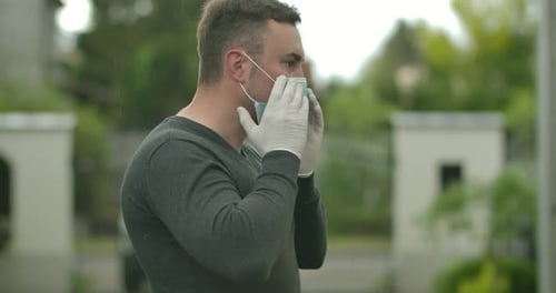 Adult Adjusting Disposable Face Mask Before Going Out