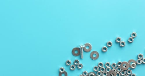 Metal Nuts Bolts Washers on Blue Background