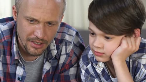 Father and Son Reading a Book Together