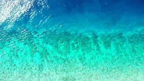 Aerial top down travel of marine seashore beach voyage by aqua blue sea and white sandy background o