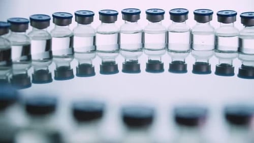 Glass Vials Lined Up in Medical Setting