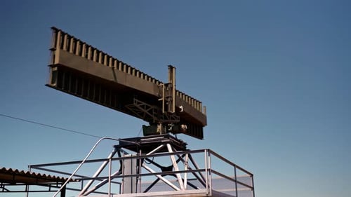 Radar Antenna Rotating Against Blue Sky