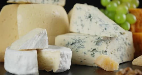 Delicious Cheeses Selection with Grapes Still Life