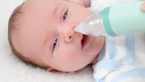 Infant Gets Nose Cleaned with Nasal Aspirator