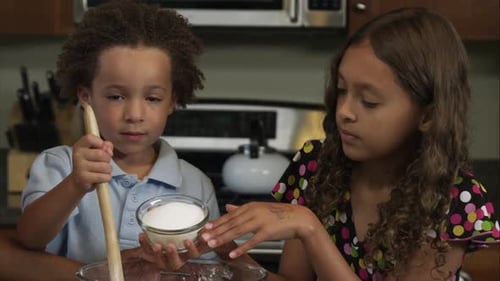Brother and Sister Baking Cookies with Sugar