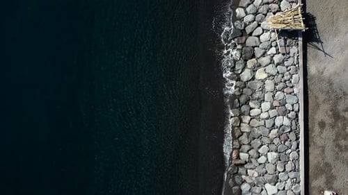 Top down view on boats on black sand beach