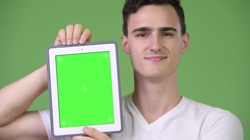 Smiling Man Holding Tablet with Green Screen