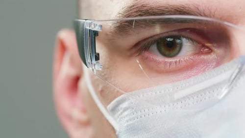 Close-up of Man Wearing Medical Mask and Goggles