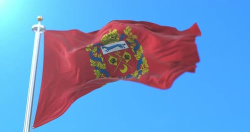 Red Flag with Golden Coat of Arms Waving in Blue Sky