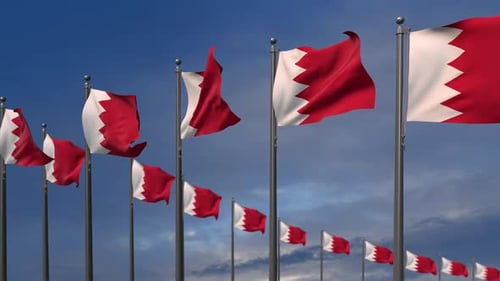 Waving Flags of Bahrain Against a Clear Blue Sky