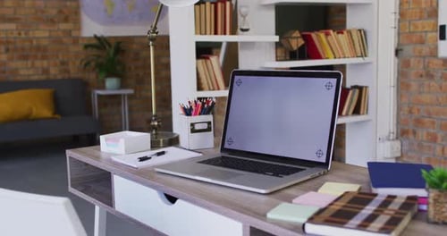 View of laptop and other school supplies on table in the classroom at school