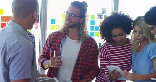 Diverse Team Collaborating with Tablets in Modern Workplace