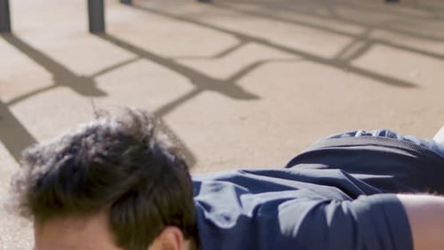 Man Doing Push-ups for Fitness in Urban Park
