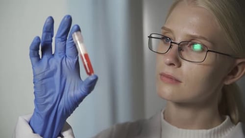 Scientist Analyzing Blood Sample in Test Tube