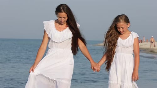 Mom and Daughter Walking By the Sea
